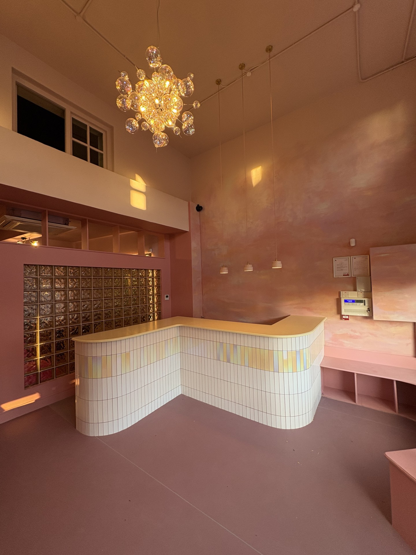 Øra reception with a glass-block wall and bubble chandelier